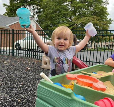 child playing in sandbox